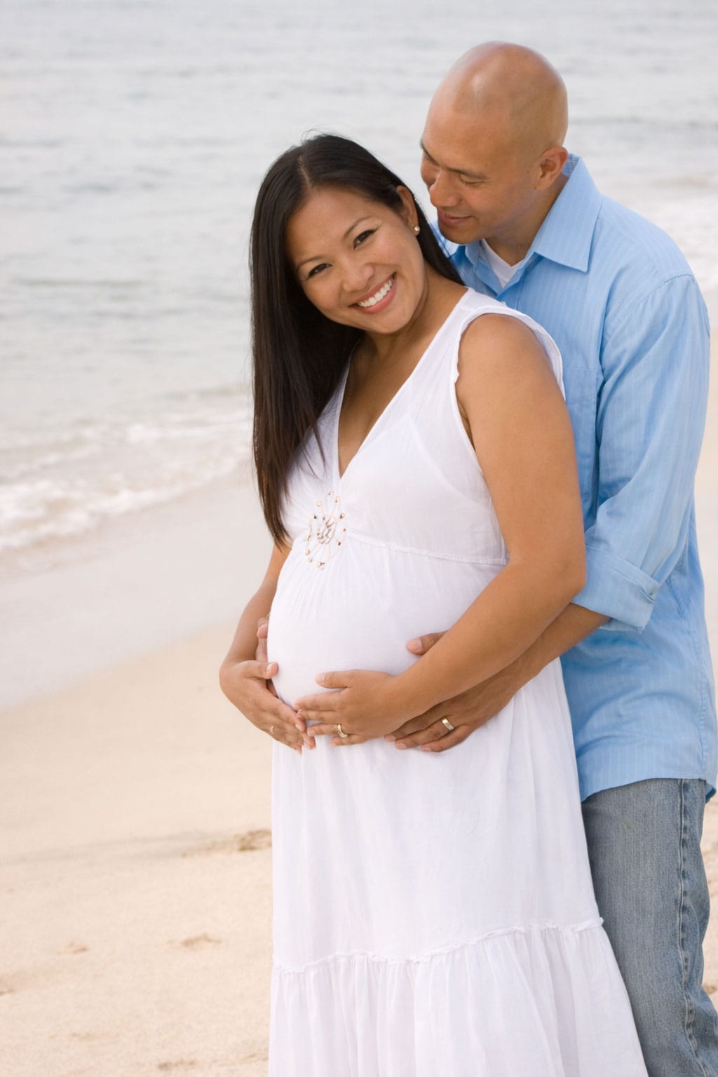 Pregnant couple enjoying a beach day
